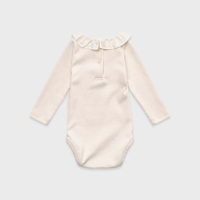 Grenouillère bébé fille en coton rose pâle à volants