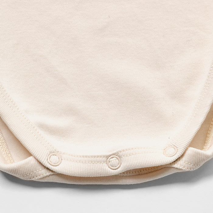 Grenouillère bébé fille en coton rose pâle à volants