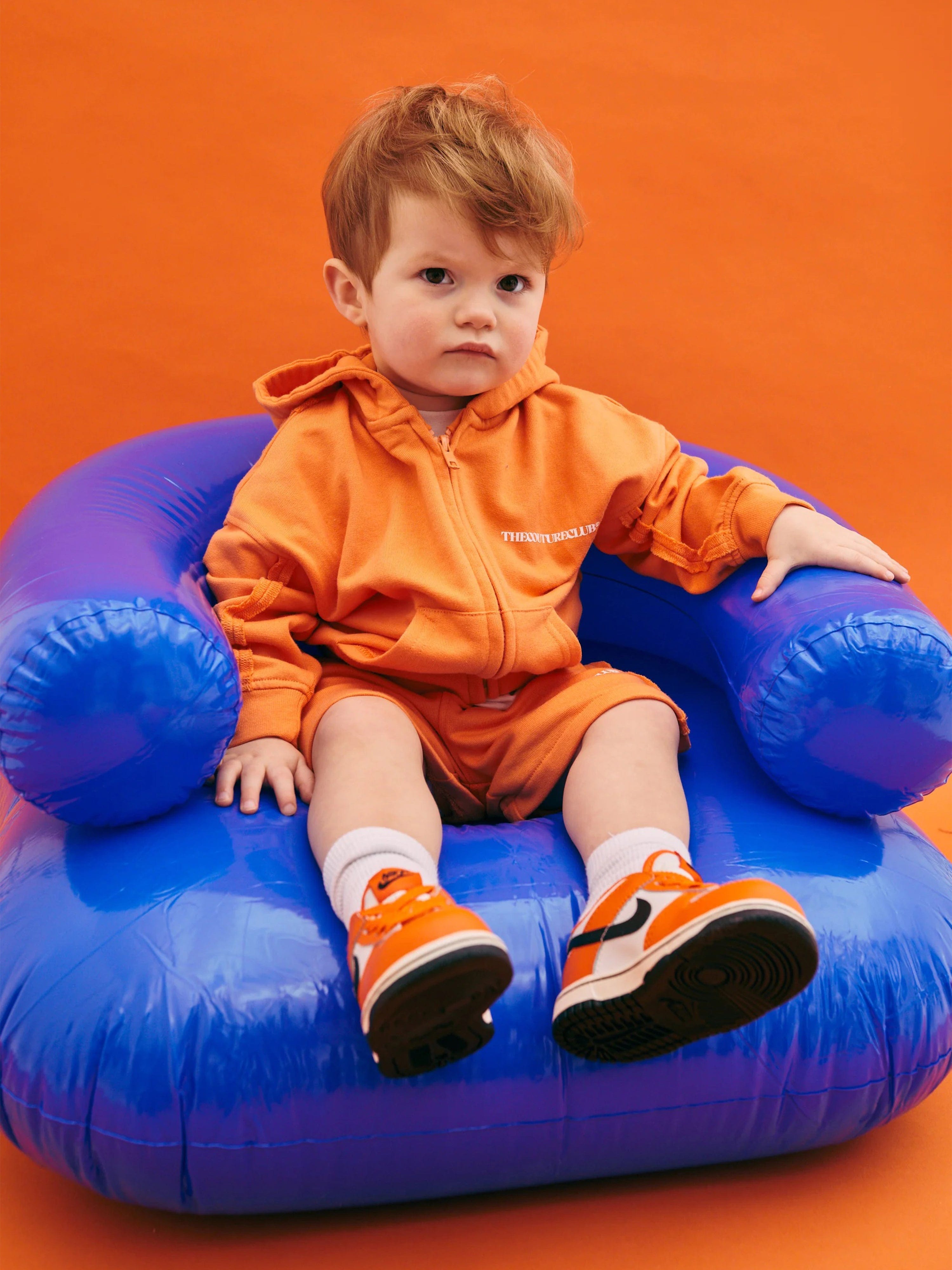 The Couture Club Kids Raw Seam Shorts in Orange